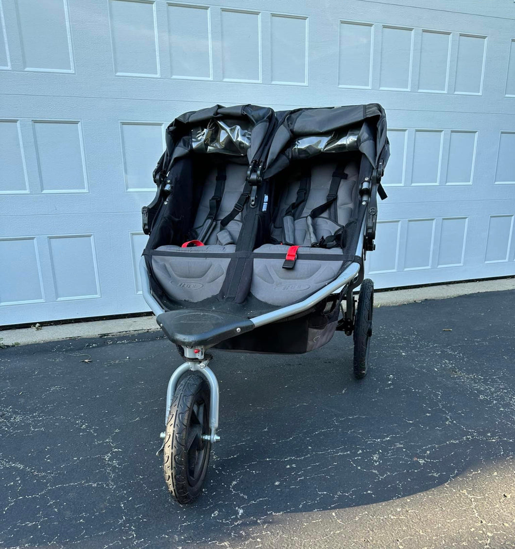 BOB double stroller with parent console. Excellent condition, no tears, swivel locking front wheel.