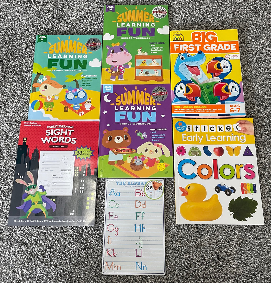 Assorted early learner activity books and dry erase board