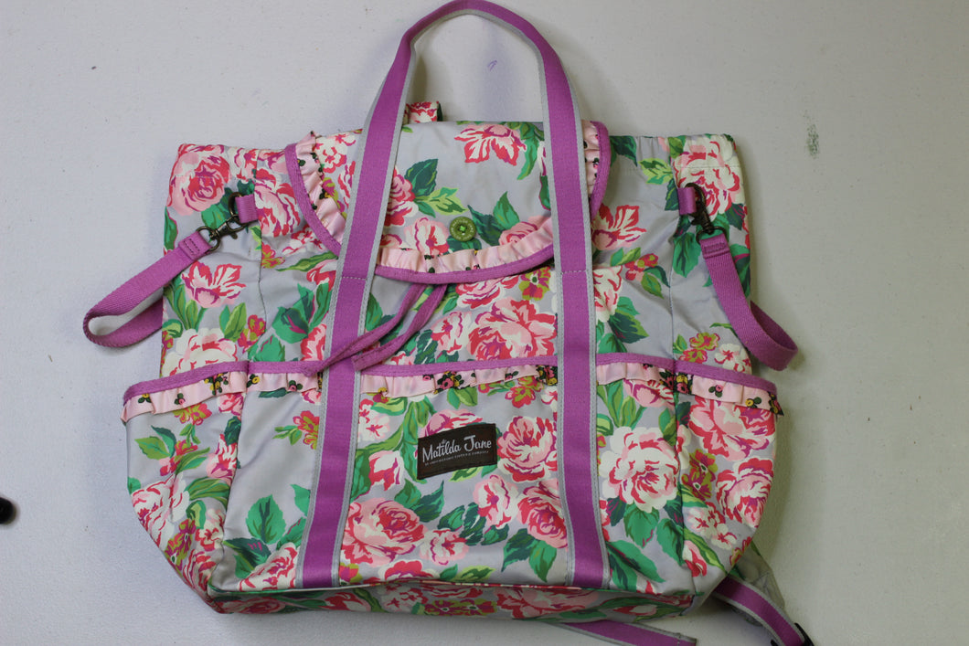 Matilda Jane Clothing floral diaper bag - has so many compartments and pockets plus attachment for hanging on your stroller.  Can be worn as a backpcak, shoulder bag or carrying handles.  Does not come with a changing pad.  One Size