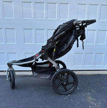 Load image into Gallery viewer, BOB double stroller with parent console. Excellent condition, no tears, swivel locking front wheel.
